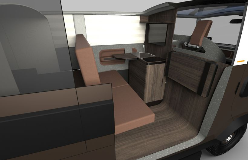 Spacious interior of an Xbus showing seats and kitchenette