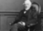 Peter Mark Roget wearing a suit and sitting in an armchair