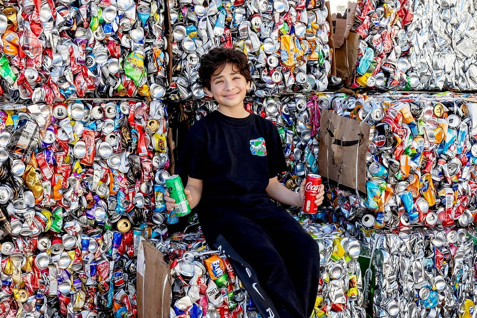 Ryan Hulance in front of thousands of empty drinks cans