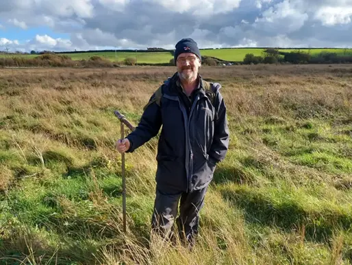 Peter "The Bogfather" Jones standing up to his knees in a Welsh bog