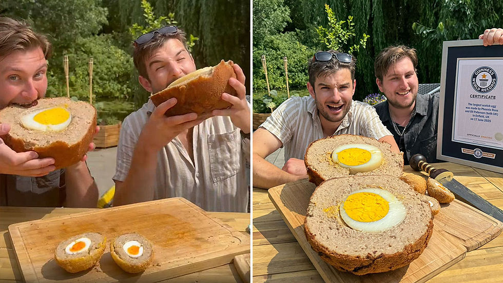 Two cooks taking a bite out of the world's largest ever scotch egg.