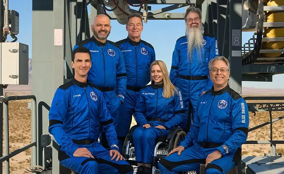 Michaela “Michi” Benthaus, in a wheelchair, with her 5 crew mates