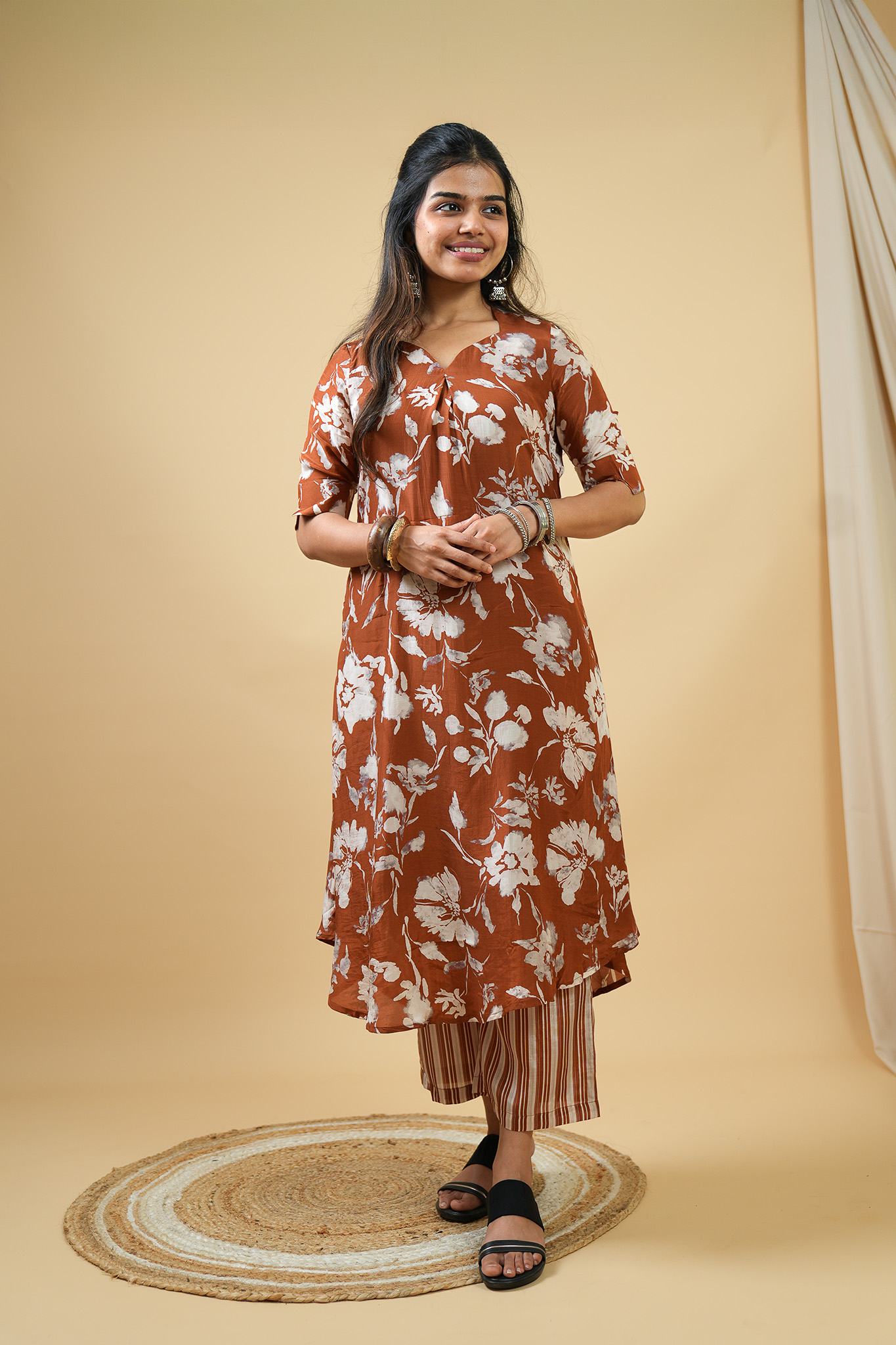 Woman smiling, wearing stylish blue patterned kurti set, casual wear for women online.