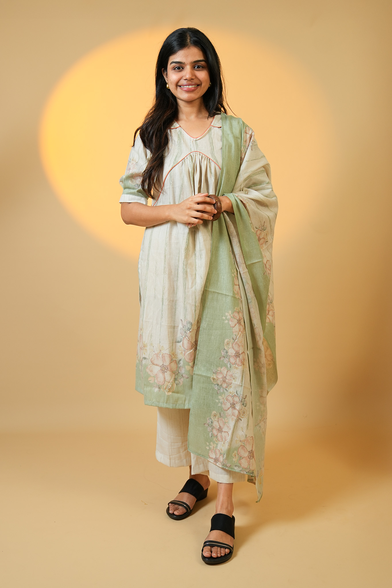 Woman smiling, wearing stylish blue patterned kurti set, casual wear for women online.