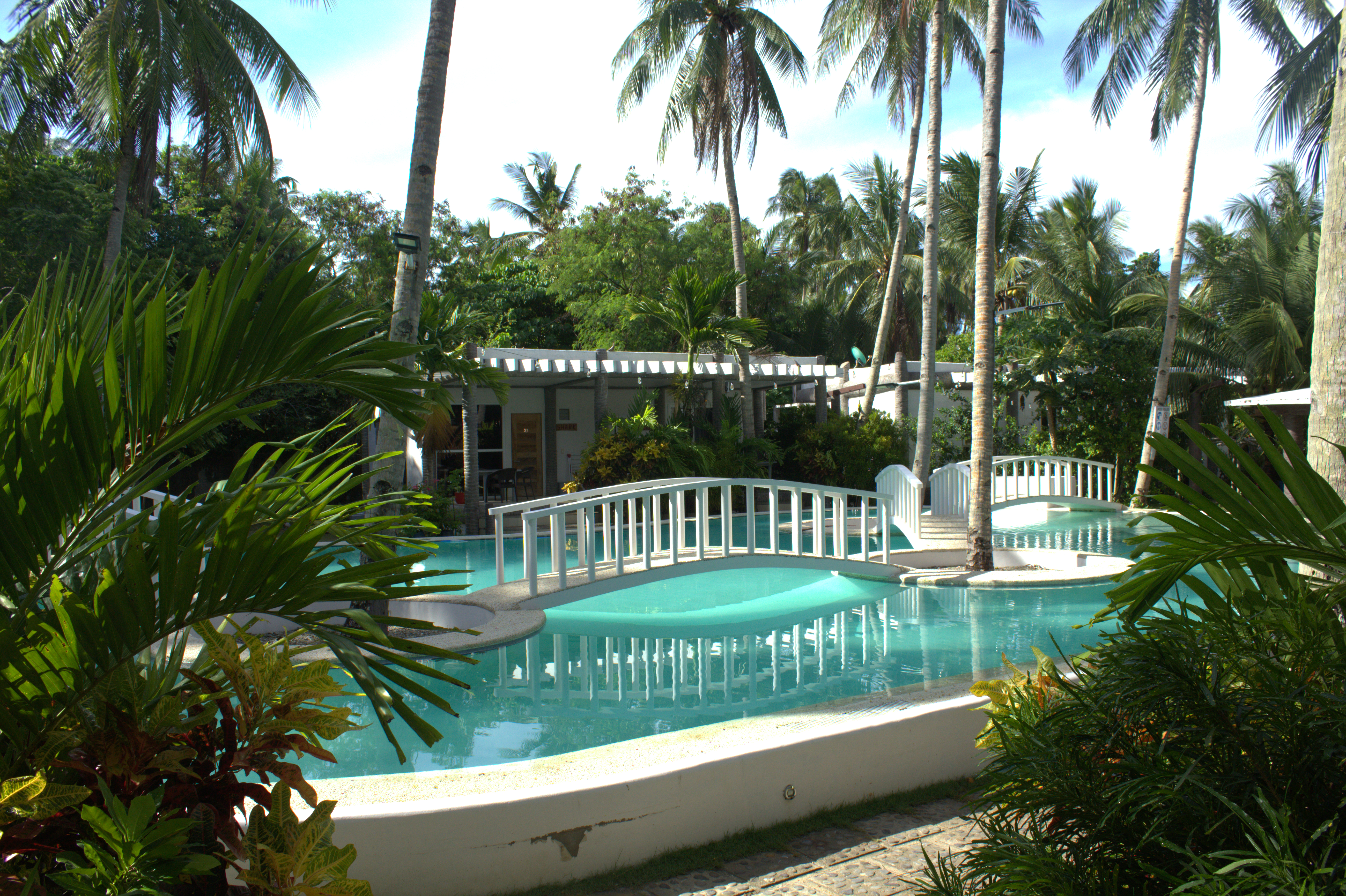 Pool and tropical gardens at Pili Beach Resort