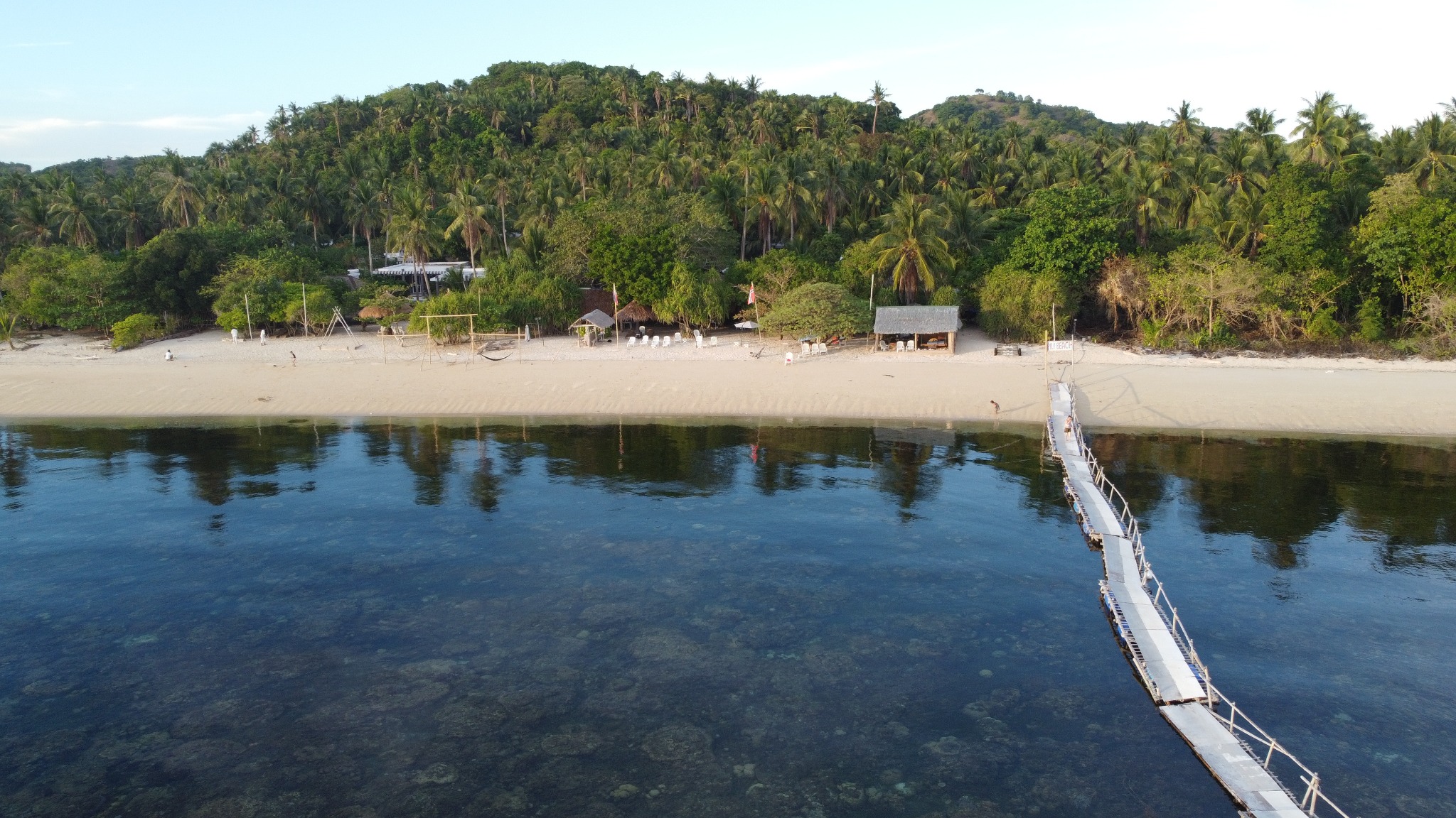 Beach and jetty in front of Pili Beach Resort