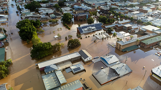 Aerial view of a town submerged in brown floodwaters