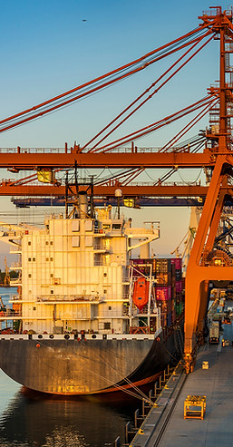 Container ship at an industrial port with cranes