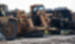 Image of various heavy equipment with some visible damage