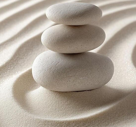 Balanced stones in a peaceful zen garden representing mindful movement and inner stability
