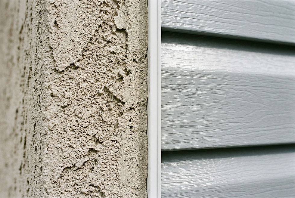 Close-up detail comparison of fresh stucco texture on the left transitioning to vinyl lap siding on the right, showing the distinct texture and finish of each material.