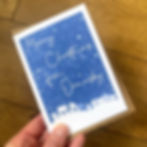 personalised christmas cards. Stating Merry Christmas from on them. Blue & white greeting card with town in the background