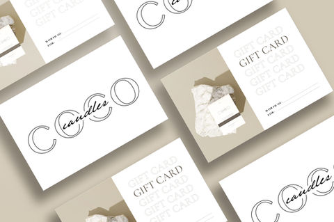 a gift card design for candles is displayed on a table
