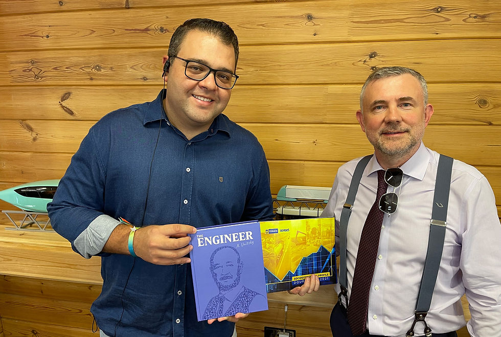 Mr. Alan Guedes with Dr. Anatoli Unitsky's book at uSky Transport office