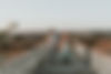 sur un pont de pierres en Sicile, un couple de mariés marche en souriant main dans la main - photographe de mariage Sicile, Italie, Côte d'Azur