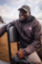 Smiling man in professional portrait photography outdoors.