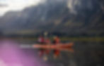 Family kayaking in Cape Town under mountain peaks.