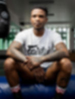 Professional portrait photography of a boxer in a gym.