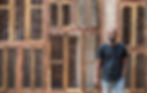Man posing for professional portrait photography by brick wall