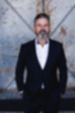 Professional portrait photography of a man in a dark suit.