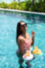 Woman in pool with drinks, commercial photographer Cape Town.