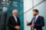 Professional portrait photography of two businessmen talking