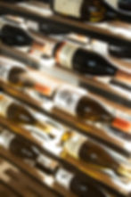 Wine bottles on a cellar rack, food photography cape town