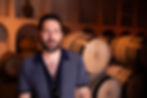 Professional portrait photography of a man in a wine cellar