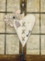 Rustic heart wall decor with musical bow, scripture tag, and key accent