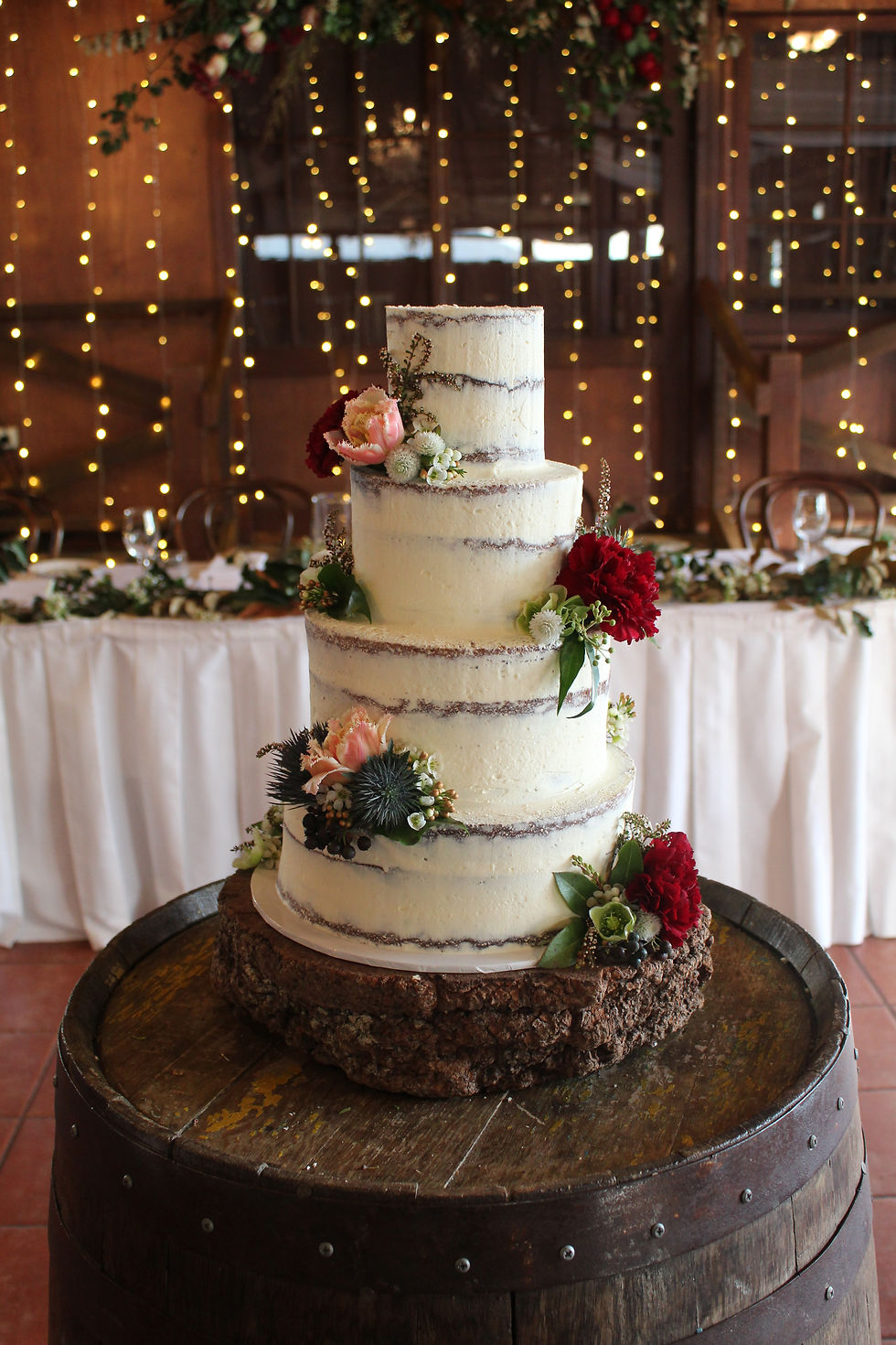 4tier semi naked cake decorated with fresh florals supplied by bridal florist