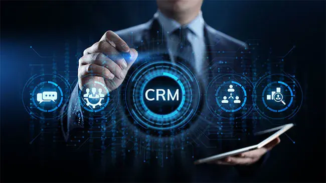 An abstract and modern digital illustration depicting AI-powered CRM systems revolutionizing sales and customer engagement. Show interconnected platforms like websites, social media, mobile apps, and email, with AI chatbots, voicebots, and AI agents interacting with customers in real-time through devices like smartphones, laptops, and voice assistants. Include elements like dynamic flowlines, personalized dashboards, and automated responses symbolizing streamlined processes and enhanced customer relationships. Use a futuristic design with vibrant colors and subtle gradients to convey innovation and efficiency in sales.