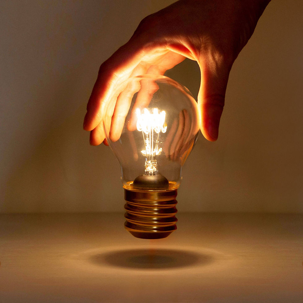glowing lightbulb with hand