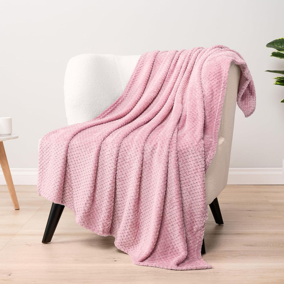 Pink fuzzy waffle throw blanket draped over a white chair