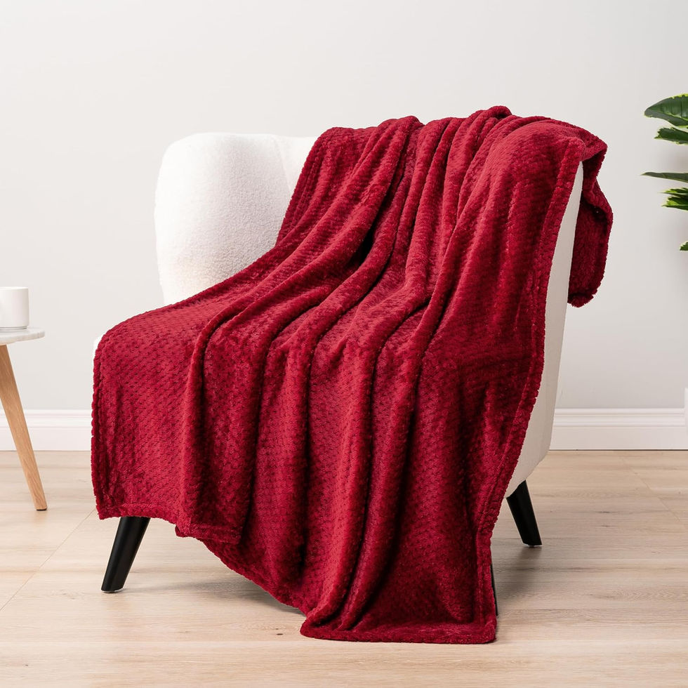 Red waffle throw blanket draped over a white chair