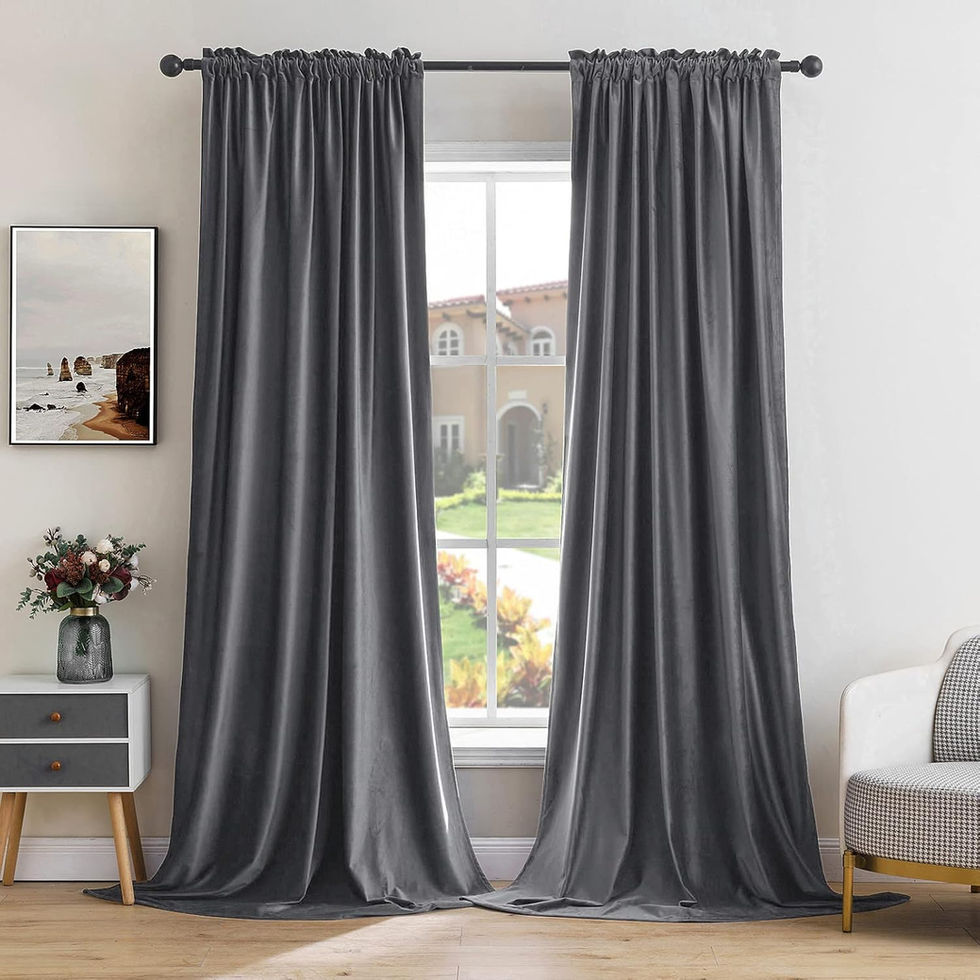 Long grey drapes hanging in a modern living room.