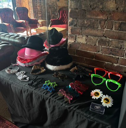 Photo booth props set up for guests on a black tablecloth lined table at the Co-Op wedding venue in Gerringong.