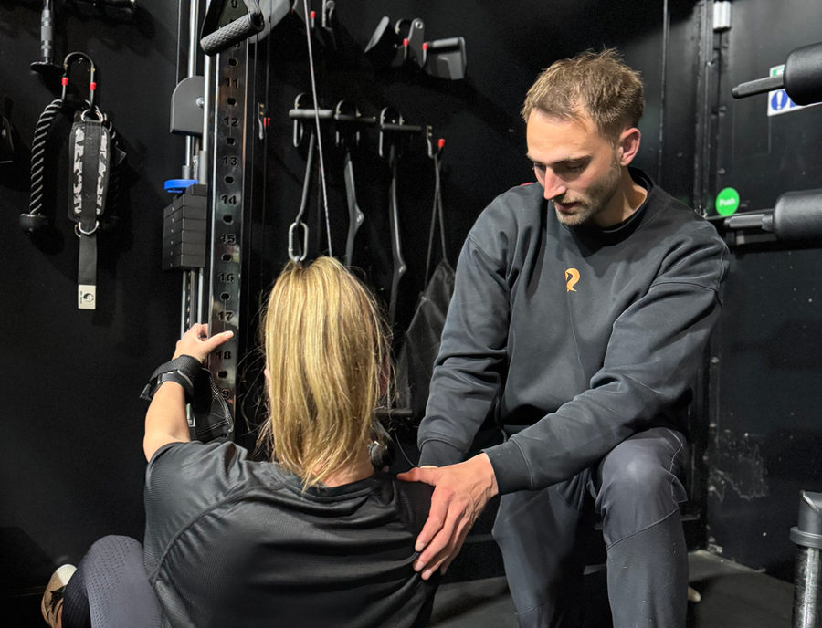 IGNYT Fitness coach working with a member