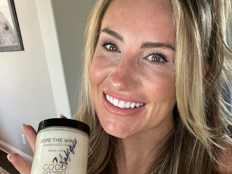 Amanda Kate Ferris holding autographed "Rope The Wind" Good Scentiments Candle