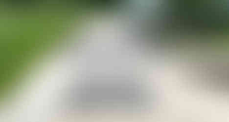 Two Tiered Patio Garden. Egyptian Limestone paving with clay paver detail. With beautiful corner steps.