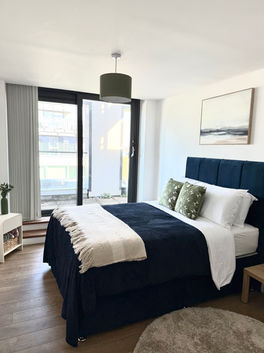 Navy blue plush bed and green cushions