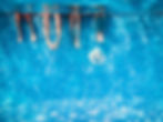 Children's and adults legs underwater in