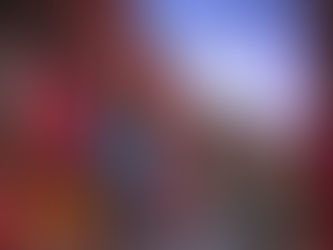 A street of colourful housing with the sun setting over it.