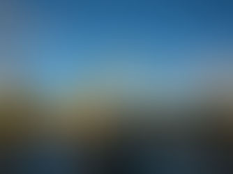 A metal bridge crossing a river with three church spires and the Inverness city skyline in the background.