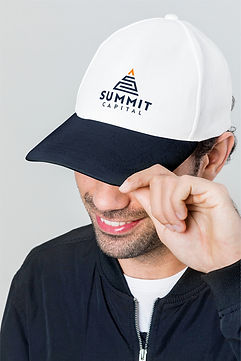 Mockup of secondary Summit Capital logo concept on white baseball cap with navy brim