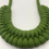 Thumbnail: close up of woven knotted recycled cotton rope necklace in a warm and vibrant green shade