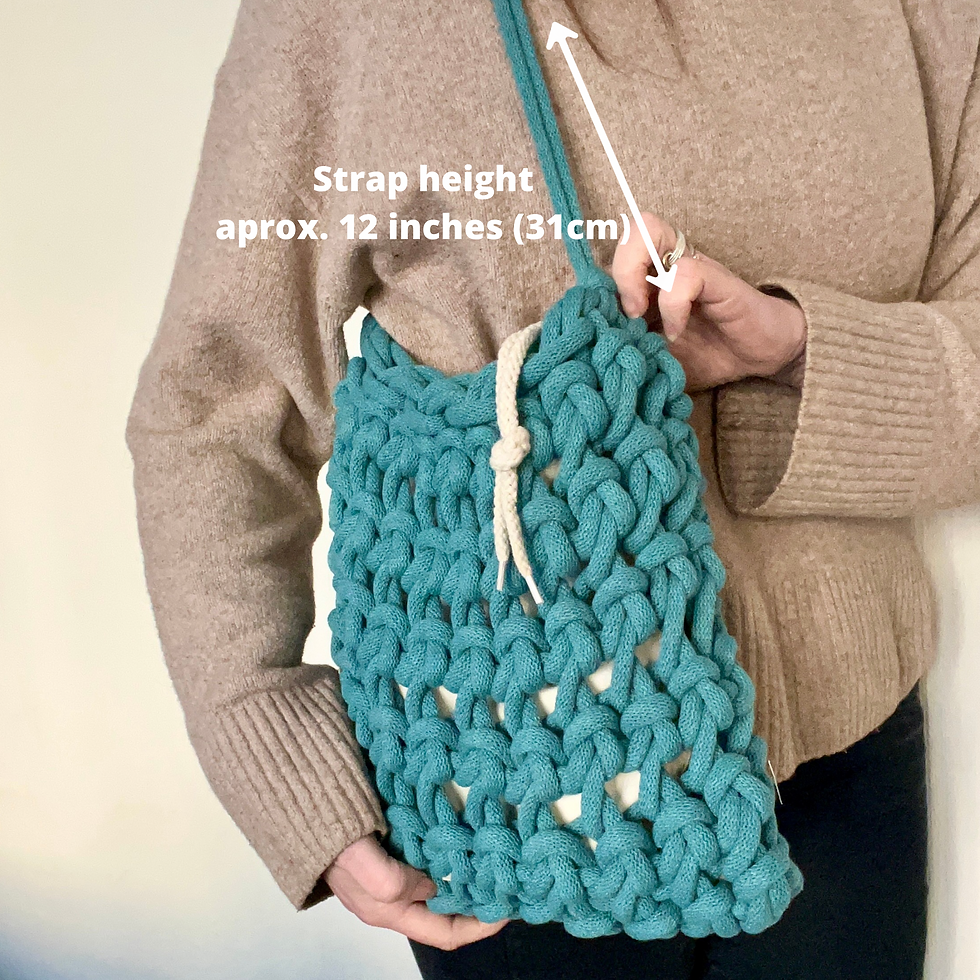 Thumbnail: person wearing teal shoulder bag hand knotted using recycled chunky cotton  with strap measurements in text