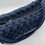 Thumbnail: top view of navy blue evening bag with zip and lining