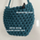Thumbnail: dark teal blue rounded shoulder bag with text -'drawstring inner' and 'soft & strong recycled cotton cord'