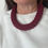 Thumbnail: lady wearing deep red/ burgundy crocheted necklace