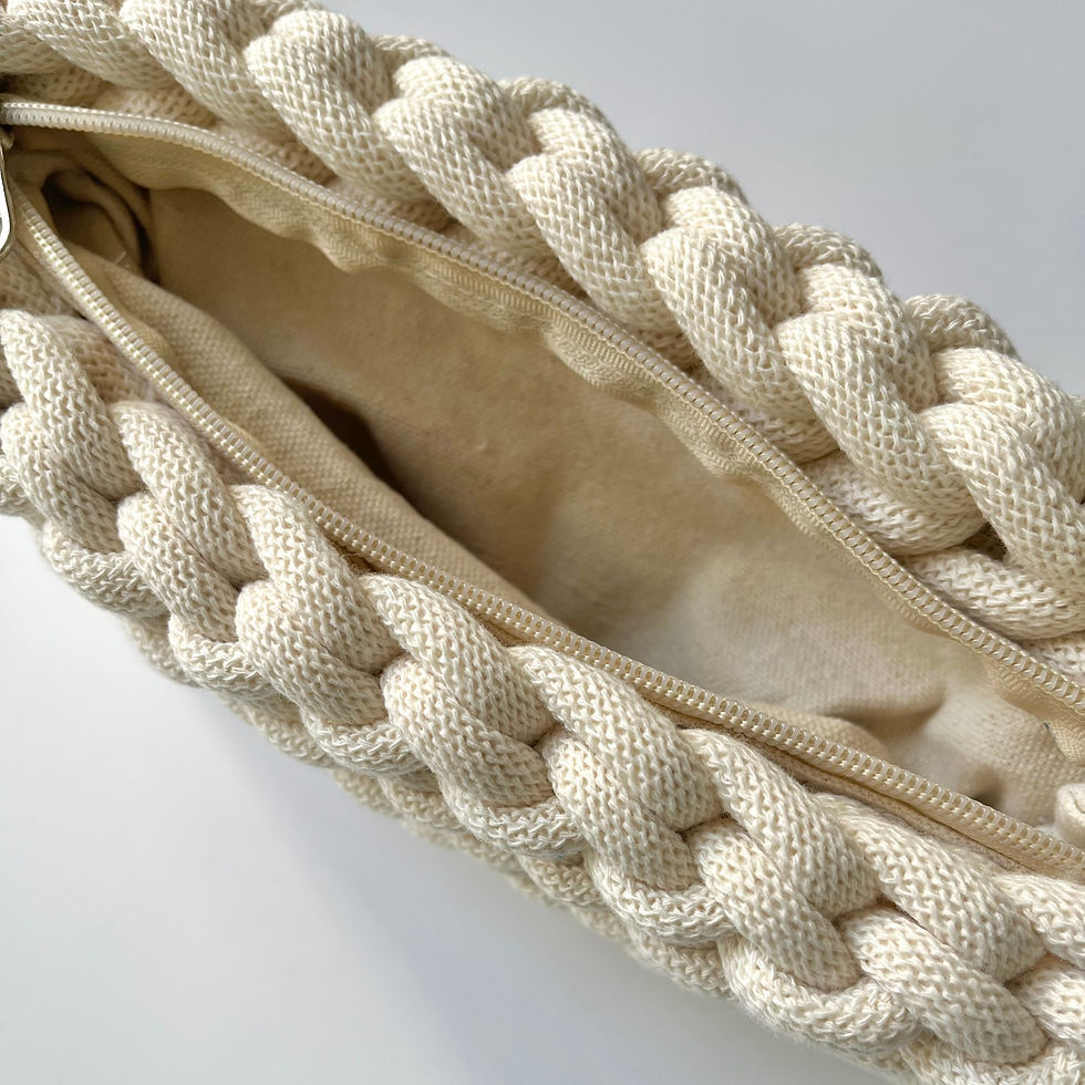 Thumbnail: top view showing inside and zip of off-white knotted cotton cord clutch bag